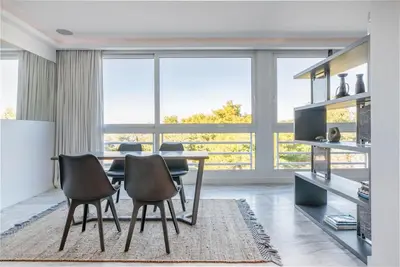 a dining room with a table and two chairs at South Blue Luxury Apartment in Vouliagmeni in Athens