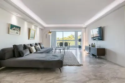 a living room with a couch and a table at South Blue Luxury Apartment in Vouliagmeni in Athens