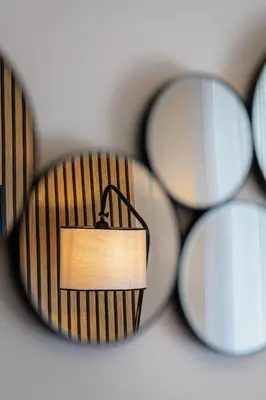 a lamp in front of a group of mirrors at Sunny & Modern apt for 3 persons in Athens