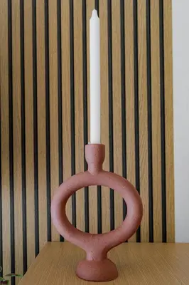 a candle holder with a white candle in it at Sunny & Modern apt for 3 persons in Athens