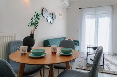 a dining room with a wooden table and chairs at Sunny & Modern apt for 3 persons in Athens