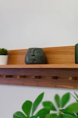 a black rock sitting on a wooden shelf at Sunny & Modern apt for 3 persons in Athens