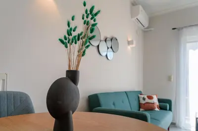 a vase sitting on a table in a living room at Sunny & Modern apt for 3 persons in Athens
