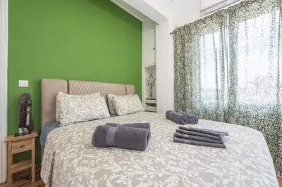 a bedroom with a bed with two towels on it at Stylish Luxury Apartment near Acropolis at Syngrou-Fix metro station in Athens