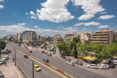 a busy city street with cars on the road at Stylish Luxury Apartment near Acropolis at Syngrou-Fix metro station in Athens