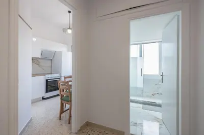 a kitchen with a glass door leading to a dining room at Stylish Luxury Apartment near Acropolis at Syngrou-Fix metro station in Athens