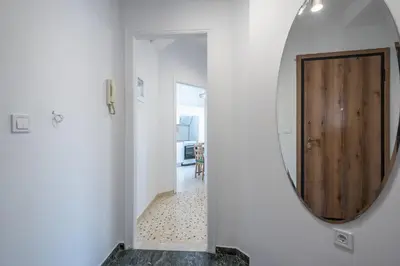 a hallway with a mirror and a door in a room at Stylish Luxury Apartment near Acropolis at Syngrou-Fix metro station in Athens