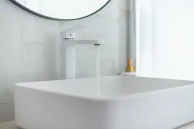 a white table with a mirror in a bathroom at Stylish Luxury Apartment near Acropolis at Syngrou-Fix metro station in Athens