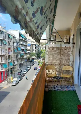 a balcony with chairs and a view of a street at Beautiful Apartment in Koukaki 5min to Acropolis in Athens