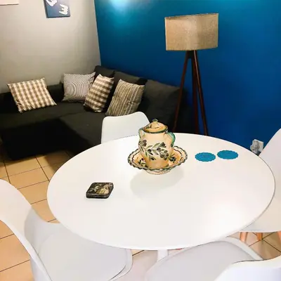 a white table and chairs in a living room at Beautiful Apartment in Koukaki 5min to Acropolis in Athens