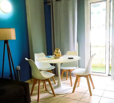 a dining room with a white table and chairs at Beautiful Apartment in Koukaki 5min to Acropolis in Athens