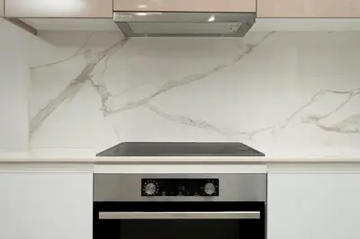 a kitchen with a white counter top with a stove at Luna Apartment by A&D Properties in Porto Rafti