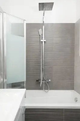 a bathroom with a shower and a bath tub at Luna Apartment by A&D Properties in Porto Rafti