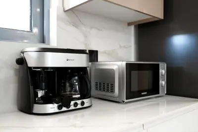 a coffee maker and a microwave on a counter at Luna Apartment by A&D Properties in Porto Rafti