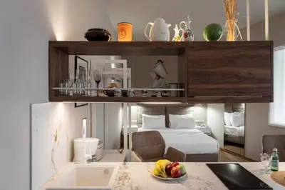 a bedroom with a bed and a table with a bowl of fruit at Olvar Penthouse Apartment in Athens
