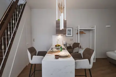 a kitchen and dining room with a table and chairs at Olvar Penthouse Apartment in Athens