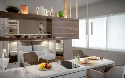 a kitchen and living room with a room with a bed at Olvar Penthouse Apartment in Athens