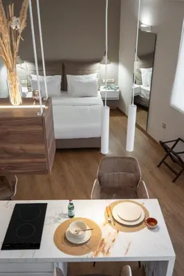 a room with a bed and a table with plates on it at Olvar Penthouse Apartment in Athens