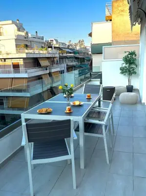 a blue table and chairs on a balcony at Evilion Maisonette in Athens in Athens