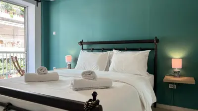 a bedroom with a large bed with towels on it at Theseus Retreat 10 min walk from the Acropolis in Athens