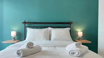 a bed with two towels on it with two lamps at Theseus Retreat 10 min walk from the Acropolis in Athens