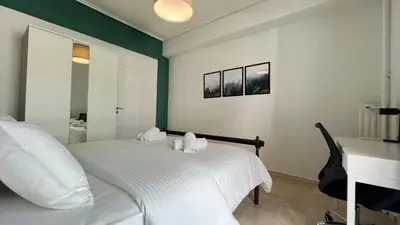 a bedroom with a white bed and a desk at Theseus Retreat 10 min walk from the Acropolis in Athens