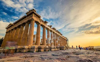a temple on top of a hill with people walking around at Theseus Retreat 10 min walk from the Acropolis in Athens