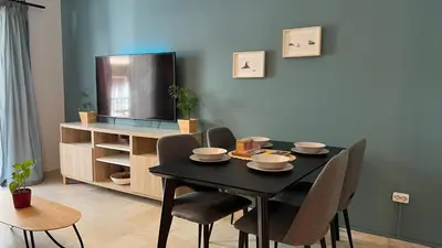 a dining room with a black table and chairs at Theseus Retreat 10 min walk from the Acropolis in Athens