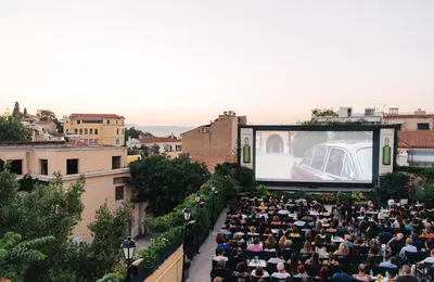 a crowd of people sitting in front of a screen at Theseus Retreat 10 min walk from the Acropolis in Athens
