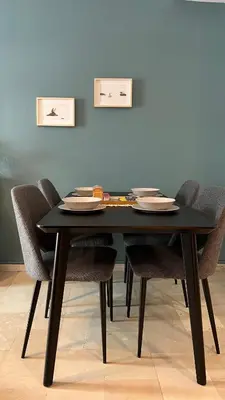 a black table with chairs and plates on it at Theseus Retreat 10 min walk from the Acropolis in Athens