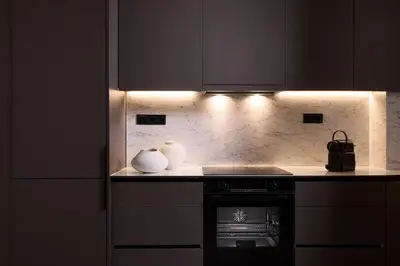 a kitchen with a stove with two vases on the counter at Acropolis Museum Grand Residence in Athens