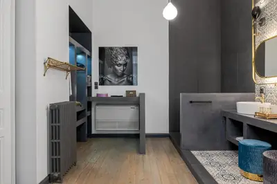 a bathroom with a sink and a vanity with a mirror at 2 Mazi Suites in Athens