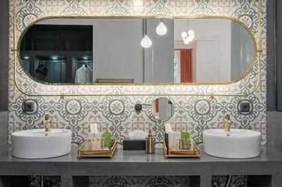 a bathroom with two sinks and a large mirror at 2 Mazi Suites in Athens