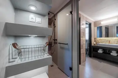 a bathroom with a sink and a toilet and a mirror at 2 Mazi Suites in Athens