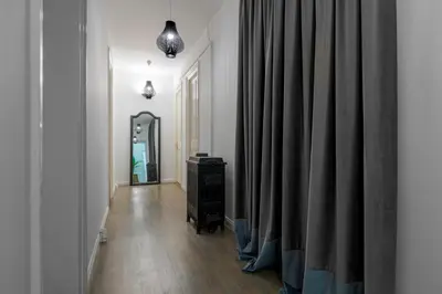 a hallway with a mirror and some curtains at 2 Mazi Suites in Athens