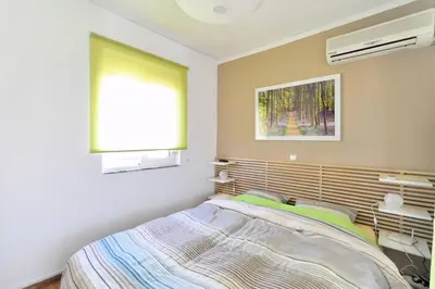 a bedroom with a bed and a window in it at 2 level apartment with terrace and Acropolis view in Athens