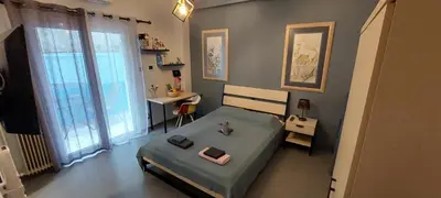 a small bedroom with a bed and a table at HoneyBee 3 - Cozy studio in the center of Athens in Athens