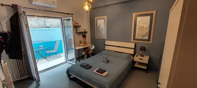 a small bedroom with a bed and a balcony at HoneyBee 3 - Cozy studio in the center of Athens in Athens