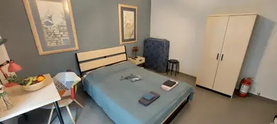 a bedroom with a bed and a desk and a table at HoneyBee 3 - Cozy studio in the center of Athens in Athens