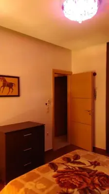 a bedroom with a bed and a dresser and a light at Διαμέρισμα στην καρδιά της Αθήνα in Athens