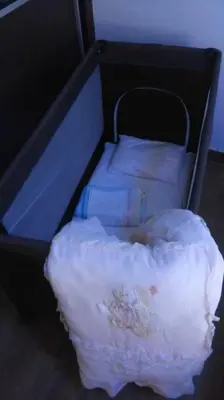 a small bed with a white blanket on it at Διαμέρισμα στην καρδιά της Αθήνα in Athens