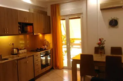 a kitchen with a table and a kitchen with a window at Διαμέρισμα στην καρδιά της Αθήνα in Athens