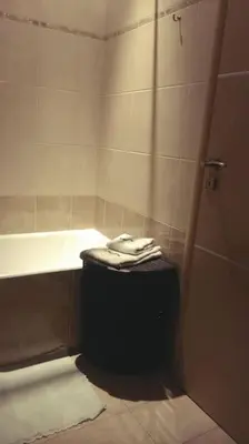 a bathroom with a shower and a tub and a sink at Διαμέρισμα στην καρδιά της Αθήνα in Athens