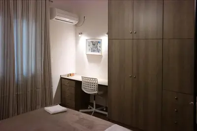 a bedroom with a desk and a cabinet and a chair at Luxury apartment near Acropolis of Athens in Athens