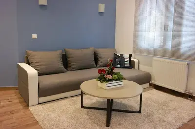 a living room with a couch and a table at Luxury apartment near Acropolis of Athens in Athens