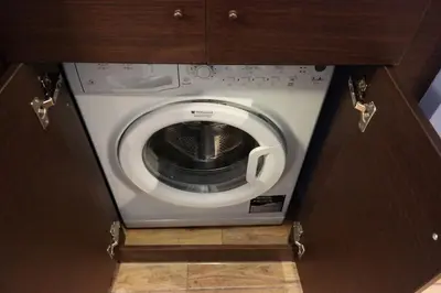 a washer and dryer in a cabinet in a kitchen at Luxury apartment near Acropolis of Athens in Athens