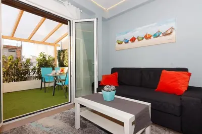 a living room with a couch and a table at Cozy apartment close to Acropolis in Athens