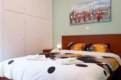 a bedroom with a bed with towels on it at Cozy apartment close to Acropolis in Athens
