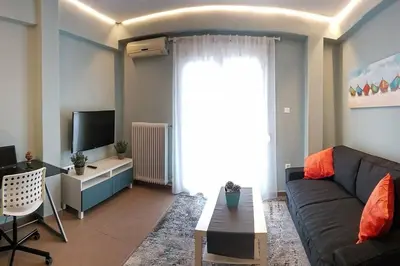 a living room with a couch and a tv at Cozy apartment close to Acropolis in Athens