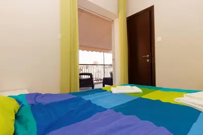 a bedroom with a bed with a colorful blanket at Big terrace near metro and Athens center in Athens